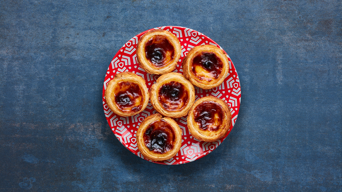 6 Nando's Pastel de Nata on a red patterned plate